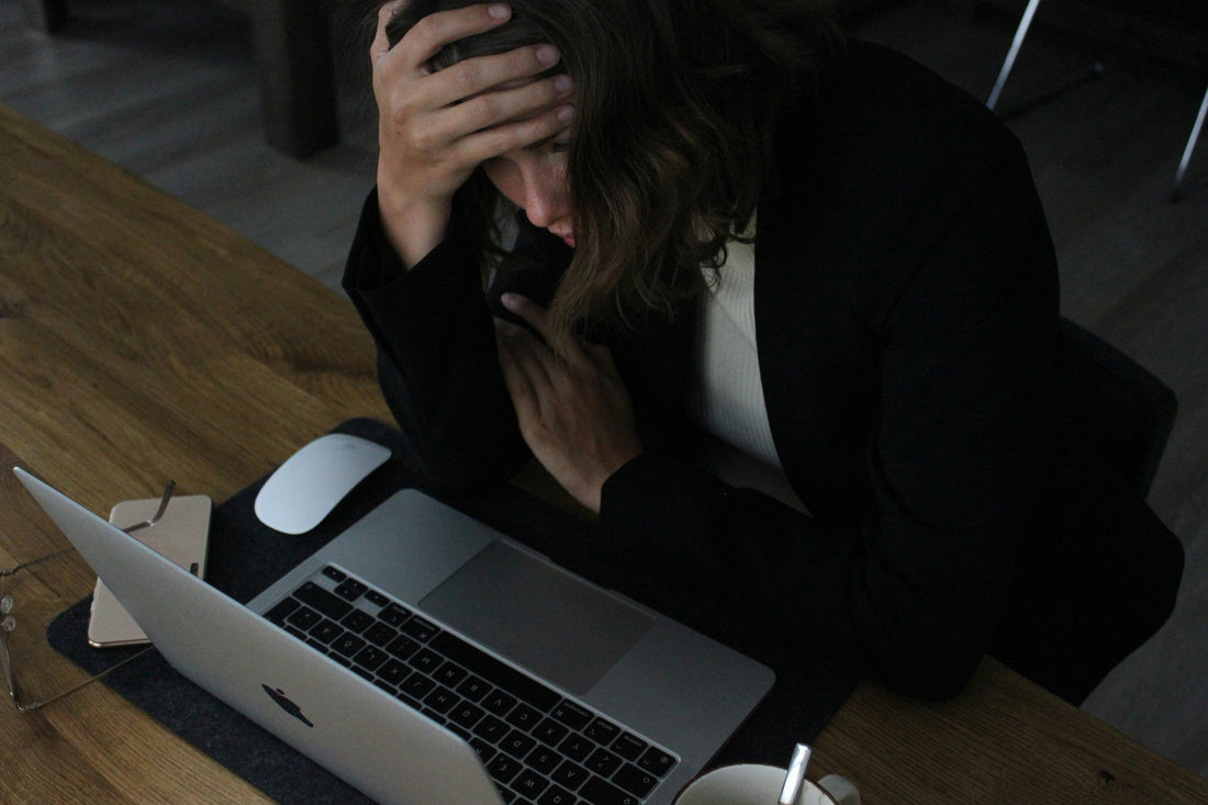 A woman stressed and anxious while drinking too much caffeine.