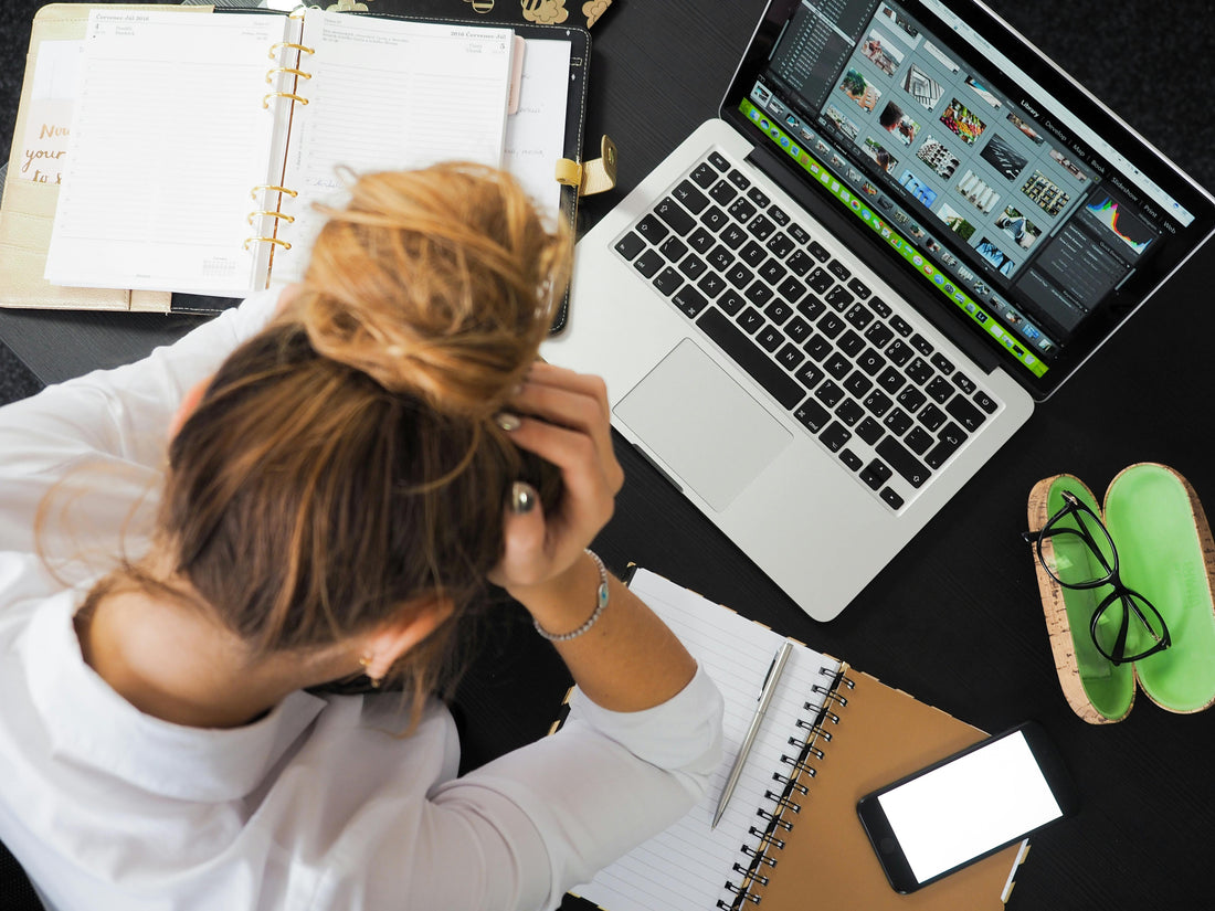 A woman stressed in front of her computer