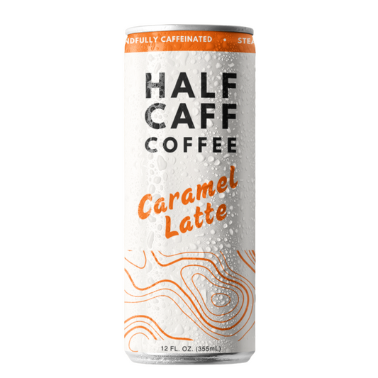 A sleek white, 12oz can of Half-Caff Coffee's Caramel Latte Flavor, a ready-to-drink coffee with 50mg of caffeine and a delicious caramel flavor. It is a white can with orange writing and a orange topographic design.