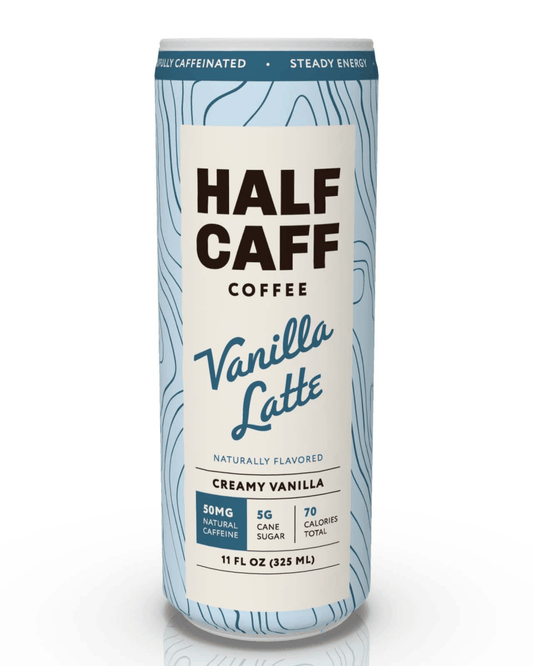 A single can of Half Caffe Coffee Vanilla Latte on a clean white background. The can features a light blue and white wood-grain patterned design with a large cream-colored label displaying the brand name 'HALF CAFF' and product name 'Vanilla Latte'.